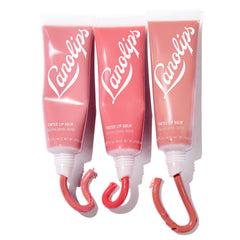 Lanolips Essentials Lip Tint Rhubarb swatch highlights a pink berry glow that enhances natural color.
