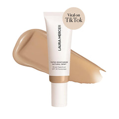 Laura Mercier Natural Dewy Sand swatch shows sheer to light coverage.