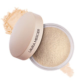 Laura Mercier translucent powder jar close-up for seamless wear.