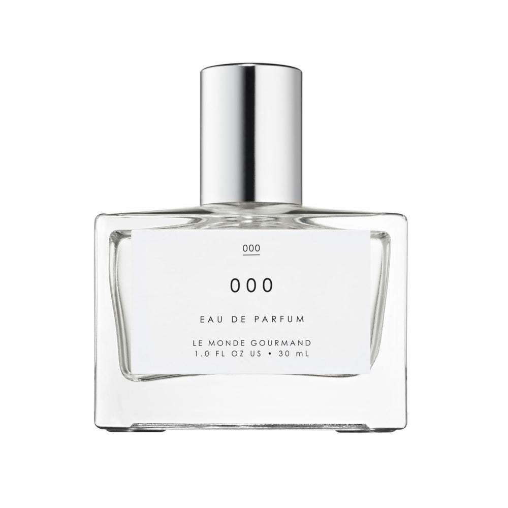 Le Monde Gourmand 000 Spray bottle close-up highlighting sandalwood notes for everyday elegance.