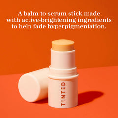 Live Tinted Superhue Serum Stick close-up applying to a dark spot for targeted correction