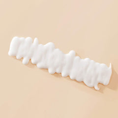 Living Proof Curl Definer finish shot highlighting curl definition and shine.