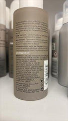 Living Proof No Frizz Vanishing Oil applied to hair on hands