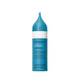 Living Proof Scalp Care Exfoliator bottle demonstrates gentle exfoliation removing buildup before shampoo.