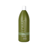 Loma Nourishing Conditioner bottle pouring for silky, hydrated hair