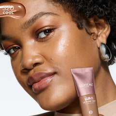 L'Oreal Paris Lumi Le Glow Tint bottle with pearls indicates reflective glow effects.