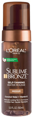L'Oreal Paris Sublime Bronze water mousse bottle showing a natural tan glow from a lightweight formula.