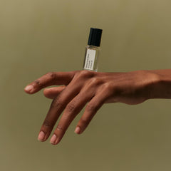 Applying Icila roll-on to pulse points for intimate, long-lasting scent performance.