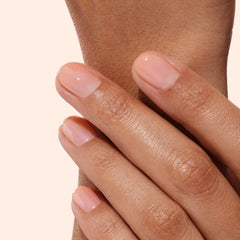 Manucurist Raspberry Pink gloss on nails emphasizes mirror-like shine and regeneration.