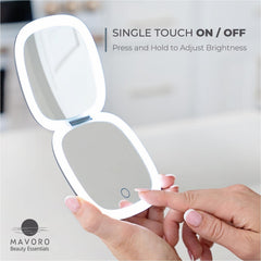 Mavoro graphite grey travel mirror in hand for on-the-go touchups.