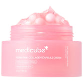 Medicube Salmon DNA PDRN pink capsules close-up for hydration and glow.