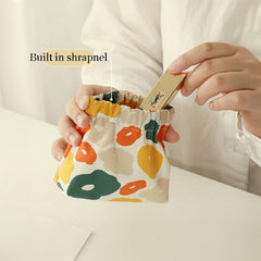 MIAO JIN compact size 4-8x4-7-inches demonstrates easy handbag fit.