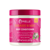 Mielle Organics Babassu & Mint Deep Conditioner bottle close-up highlighting hydrating formula.