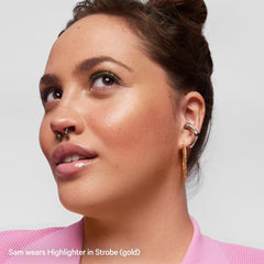 Milk Makeup Highlighter on collarbones for a luminous body glow.