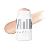 Milk Makeup Turnt highlighter on cheekbone for radiant illumination.