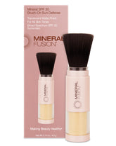 Mineral Fusion brush-on sunscreen compact close-up with translucent matte finish for daily wear.