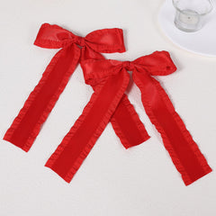Miroksh red satin bow clip close-up showing double ruffle edge detail