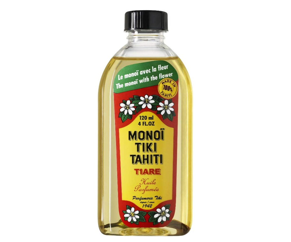 Monoi Tiki Tahiti coconut oil bottle pouring for skin and hair nourishment.