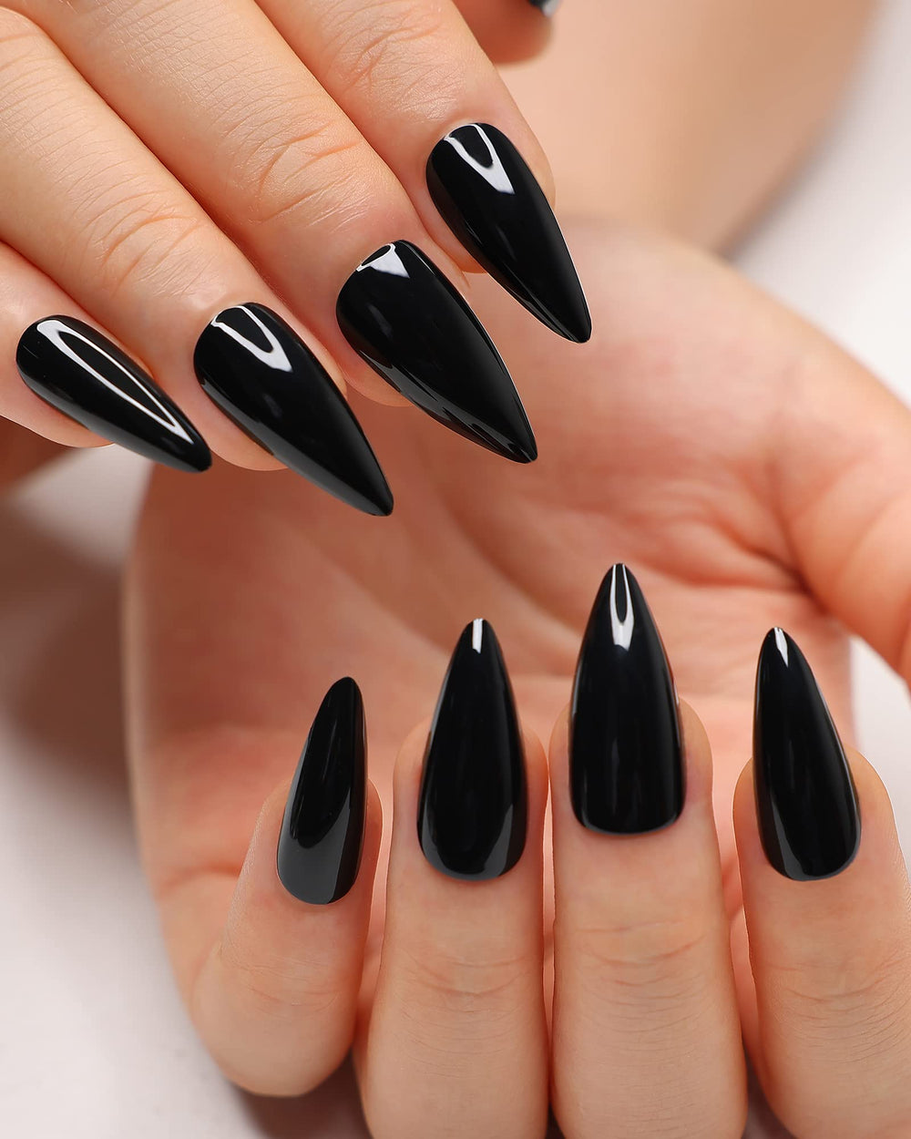 Morily black press-on nails in stiletto almond shape ready for dramatic day-to-night looks.