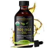 Mother Nature Organics moringa seed oil bottle closeup for skin hydration and glow.