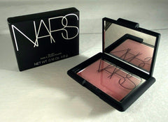 NARS Orgasm swatch on skin demonstrates peachy pink with golden shimmer for warmth.