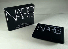 NARS Orgasm blush on cheek during application demonstrates buildable color and natural warmth.