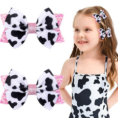 NCMAMA cow-print hair bow pink grosgrain with alligator clip for secure pigtails.