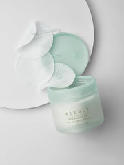 NEEDLY Mild Cleansing Pad grid-embossed side highlights buildup removal capability