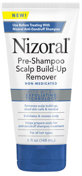 Nizoral pre-shampoo bottle on sink being applied to dry scalp for exfoliation.