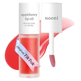 NOONI Appleberry Lip Oil bottle close-up showing glossy, hydrating formula.