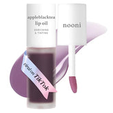 NOONI Appleblacktea lip oil tube closeup showing silky hydration