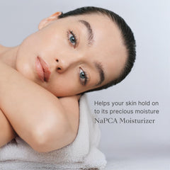 Nu Skin NaPCA Moisturizer pump demonstrating quick-absorbing, non-greasy formula.