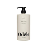 Odele Leave-In Conditioner bottle closeup shows frizz control and moisture boost.