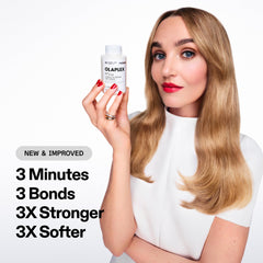 Olaplex N°3PLUS hands applying product to damp hair for fast repair
