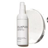 Olaplex Volumizing Blow Dry Mist bottle pour for weightless volume and shine.