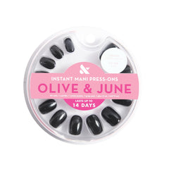 Olive & June Instant Mani glue bottle and nails ready for at-home salon-quality results.