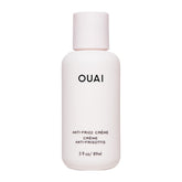 OUAI anti-frizz cream travel size bottle shows portable frizz control for on-the-go styling.