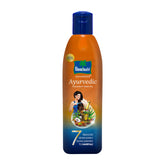 Parachute Advansed coconut hair oil bottle pouring nourishes the scalp