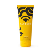 PATTERN Beauty Leave-In Conditioner being applied on curly hair for hydration.