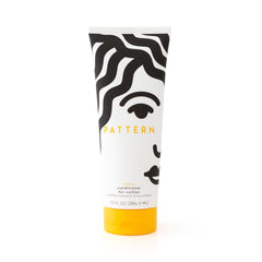 Pattern Heavy Conditioner bottle on shelf highlights rich hydration for curly hair.