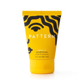 PATTERN Leave-In Conditioner bottle opened showcasing rich texture.