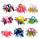 PIDOUDOU pack of 18 mixed-color curly korker bows for kids, versatile hair accessory.