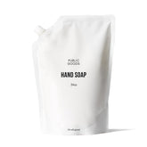 Public Goods hand soap bottle on sink offering everyday cleansing with fresh grapefruit-mandarin scent.