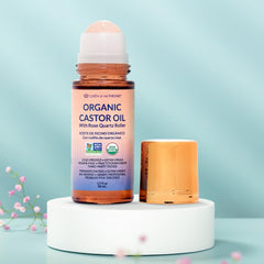 Castor oil pack setup with Queen of the Thrones roll-on for precise topical use