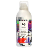 R+Co ANALOG cleansing foam bottle pour demonstrates weightless conditioning and frizz control