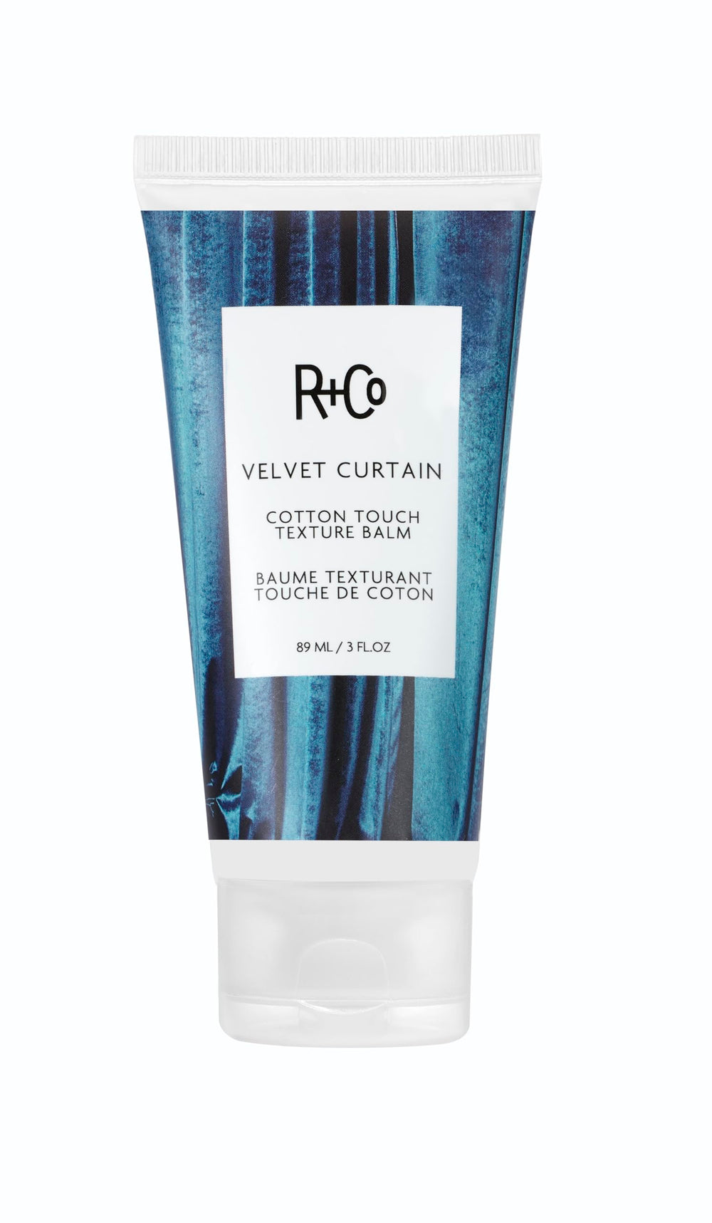 R+Co Velvet Curtain balm jar close-up, soft volume and light hold.