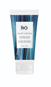 R+Co Velvet Curtain balm jar close-up, soft volume and light hold.
