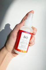 R+Co Hot Spell Thermotech Balm hair application demonstrates frizz control.