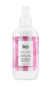 R+Co Candy Stripe bottle front view — detangler preps hair for styling.