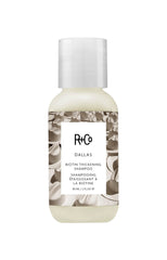 R+Co Dallas Thickening Shampoo bottle close-up for volumizing hair.